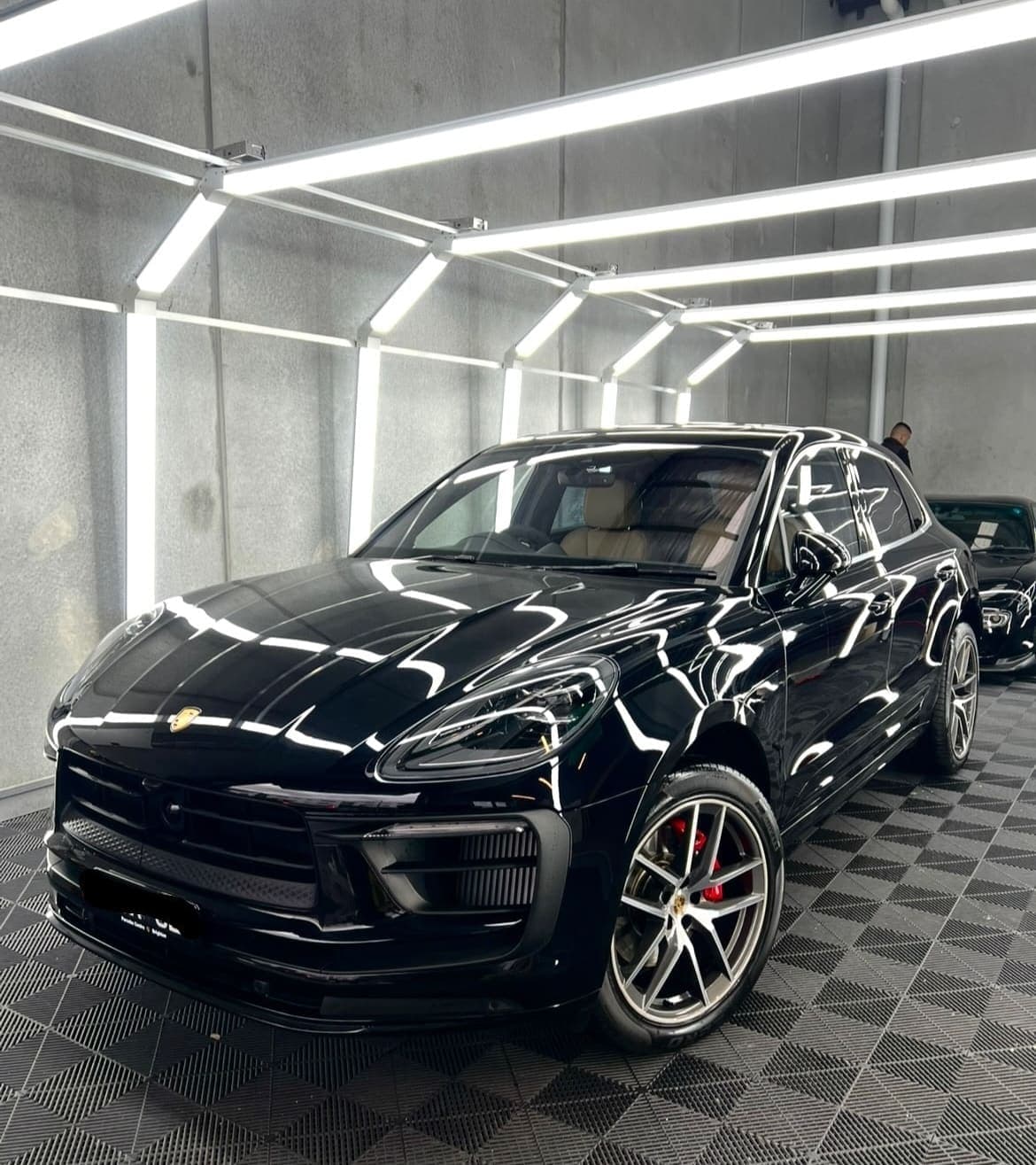 Black Porsche Macan with ceramic coating in the workshop